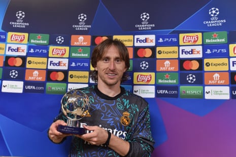 Real Madrid’s Luka Modric proudly shows off his player of the match award.