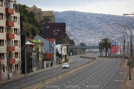 A car is seen in a street of Valparaíso during an evacuation in Chile
