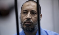 Saadi Gaddafi, son of Muammar Gaddafi, sits behind bars during a hearing at a courtroom in Tripoli, Libya in 2016. Gaddafi has been released from jail, according to reports. 