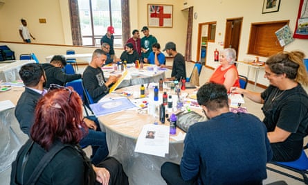 Residents on the Bibby Stockholm taking part in an art class at Portland community venue