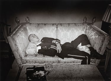 Jordi the lounge lizard lies asleep in uniform on an ornate sofa