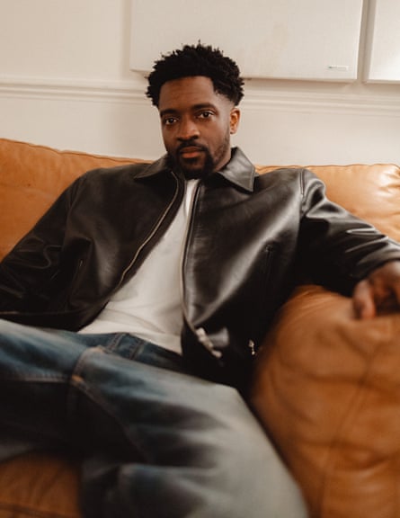 Guvna B sitting on a sofa