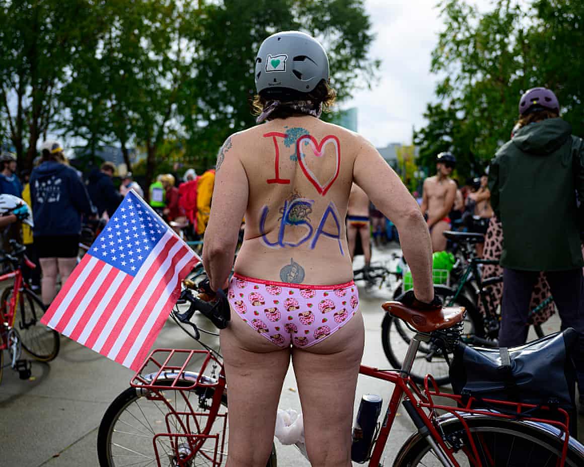 A near-naked participant stands with their back painted