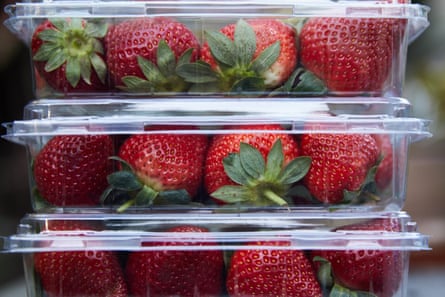 Three punnets of strawberries stacked on top of each other