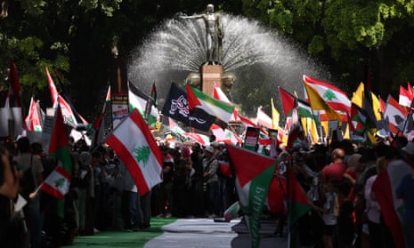 Palestinian and Lebanese flags waving near the fountain in Sydney's Hyde Park.