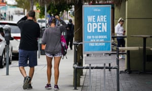 Customers walk past an open sign at Rubio’s Coastal Grill in Long Beach, Calif.