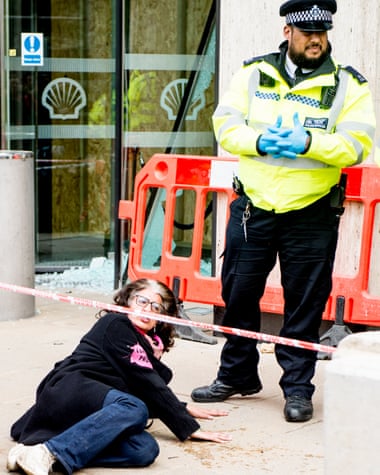 Farhana Yamin glues her hands to the pavement outside the Shell building in London.