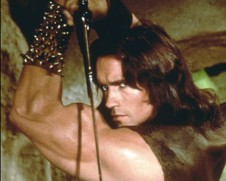 Arnold Schwarzenegger with long hair, holding a sword over his shoulder