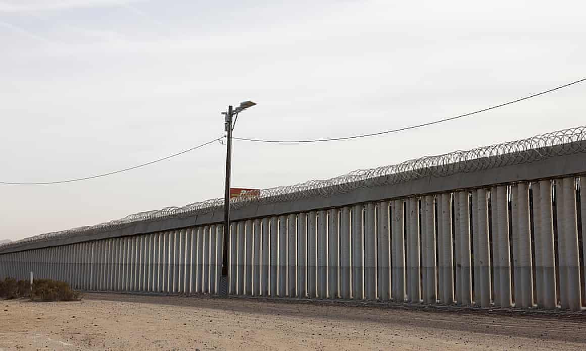 A wall lines the US-Mexico border in San Diego, California.