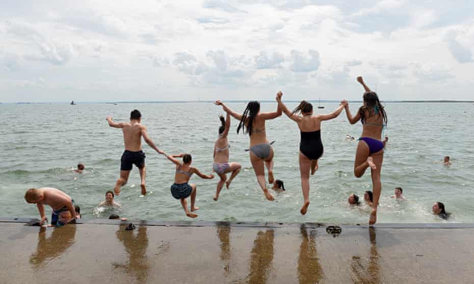 Kids jumping into the water in Leigh-on-Sea, Essex.