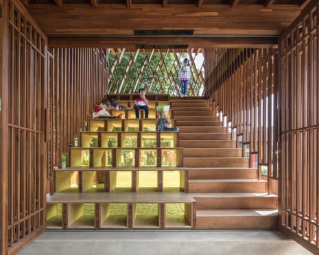 children sit and stand on wooden steps