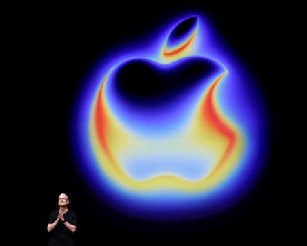 Tim Cook in front of a projected Apple logo in the style of a thermal image