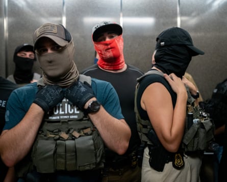 three people with masks over their faces