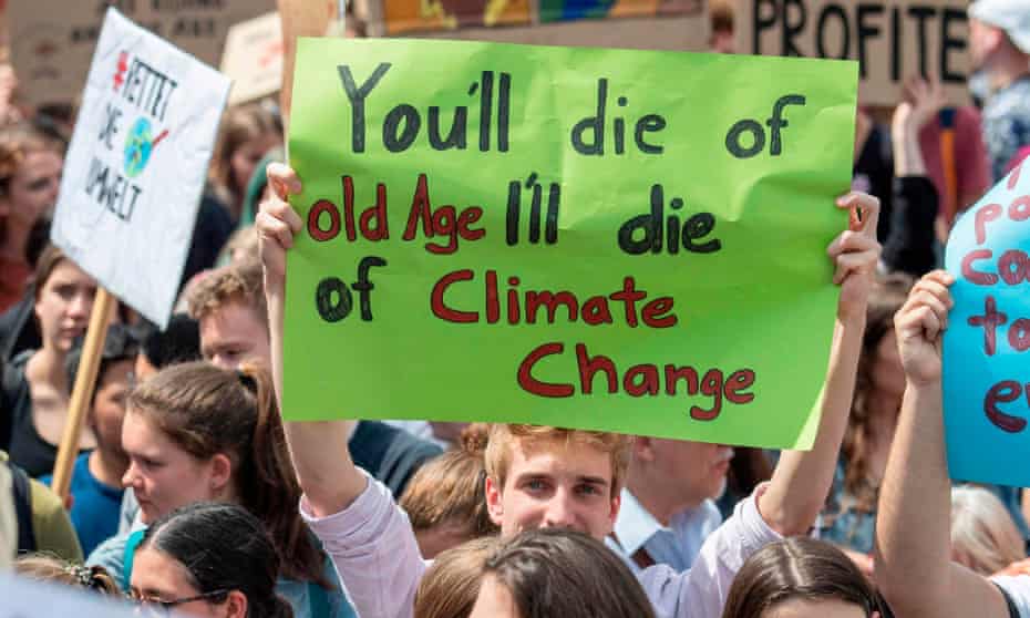 A demonstrator holds a poster reading “You’ll die of old Age - I’ll die of Climate Change” in Frankfurt, Germany.