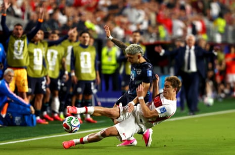 Julio Enciso (19) of Paraguay is tackled by Kenan Yildiz (11) of Turkey.