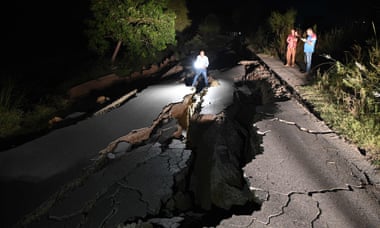 A news cameraman films a damaged road following an earthquake on the outskirts of Mirpur on September 24, 2019.