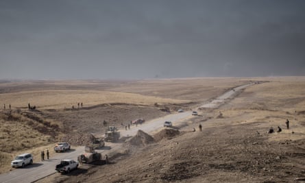 A bulldozer clears a roadblock during the peshmerga’s advance near Bashiqa