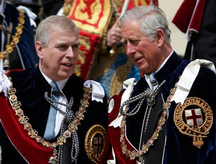 Prince Andrew and the then Prince Charles wearing gold chains, red sashes and black capes