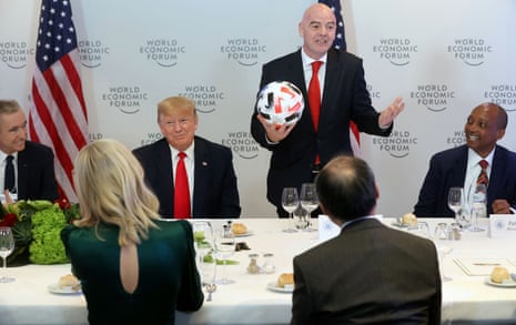 U.S. President Donald Trump listens to FIFA President Gianni Infantino speak during a dinner with global CEOs during the 50th World Economic Forum (WEF) annual meeting in Davos, Switzerland.