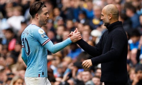 Manchester City's Jack Grealish shakes hands with manager Pep Guardiola after being substituted