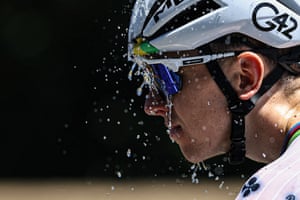 UAE Team Emirates - XRG team’s Slovenian rider Tadej Pogacar douses himself with water to cool down as he cycles during the 7th stage