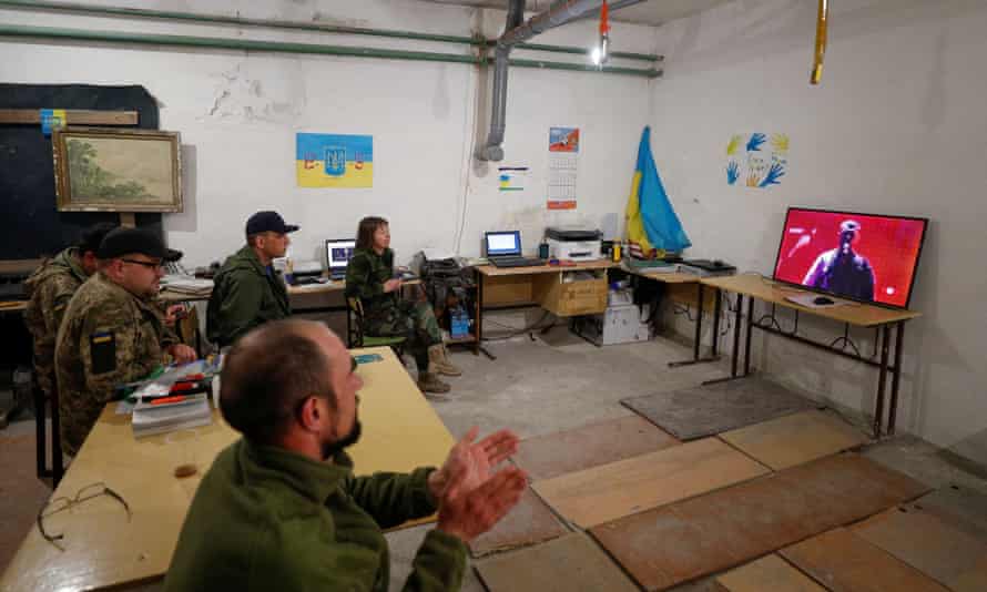 Ukrainian service members watch 2022 Eurovision Song Contest from a basement in the Kyiv region.