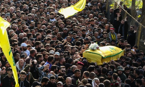 Hezbollah fighters and supporters attend the funeral on 9 January of the military commander Wissam Tawil, killed in an Israeli airstrike.