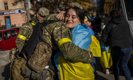 A Kherson resident hugs a Ukrainian defence force member in Kherson, southern Ukraine, Monday, 14 November.