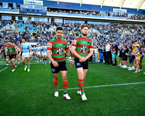 Jai Arrow walks out with a teammate for his 99th game as a South Sydney player.
