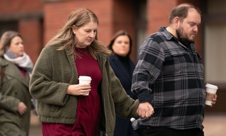 Sarah and Gary Andrews, a bereaved couple, hold hands as they walk towards a court.