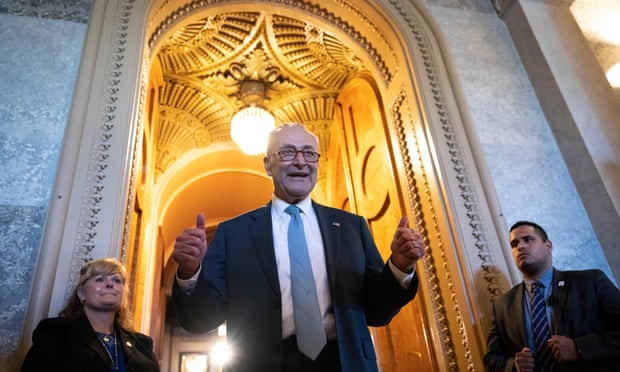 The Senate majority leader, Chuck Schumer, gives the thumbs up as he leaves the Senate chamber after passage of the Inflation Reduction Act.