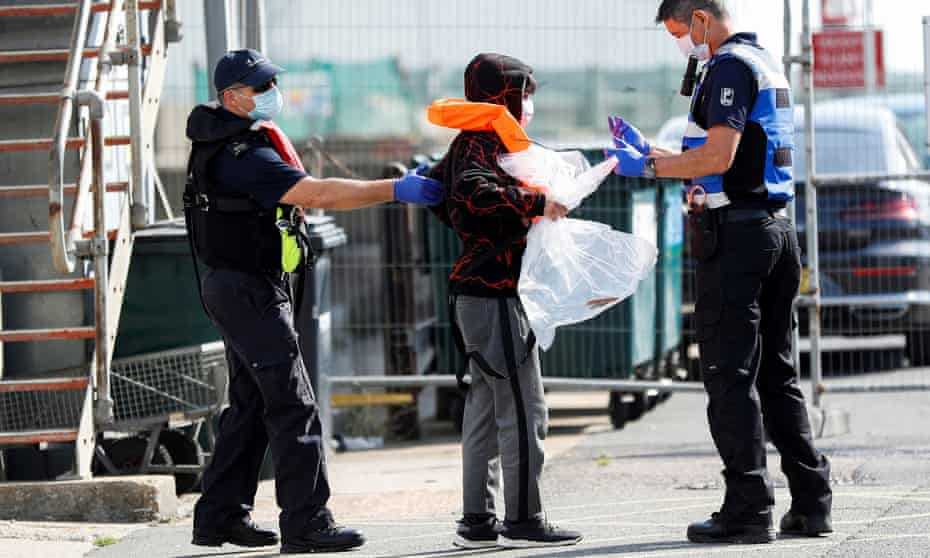 A migrant rescued from the Channel by UK Border Force arrives at Dover harbour.