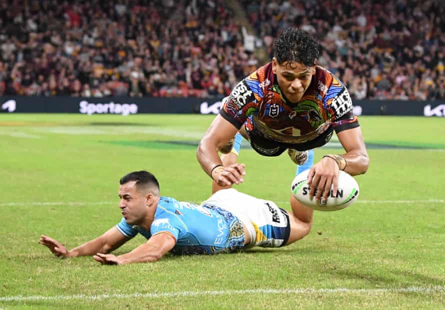 Selwyn Cobbo (top) of the Broncos scores a try during the NRL Round 12 match between the Brisbane Broncos and the Gold Coast Titans at Suncorp Stadium in Brisbane, Friday, May 27, 2022.