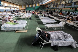 Ukrainian refugees who fled the war take shelter in the main hall of an athletics complex in Moldova’s capital Chisinau.