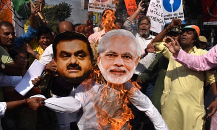 Protesters burn effigies of Narendra Modi and Gautam Adani