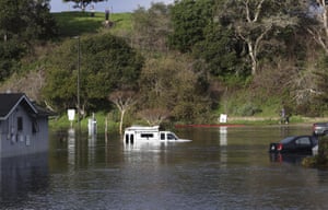 Tsunami surge inundates a car park at the top of the Upper Harbor in Santa Cruz, California