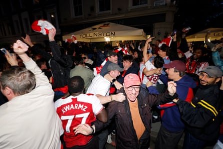 Arsenal fans celebrate outside the Tollington Arms pub as Arsenal were confirmed as Premier League champions,
