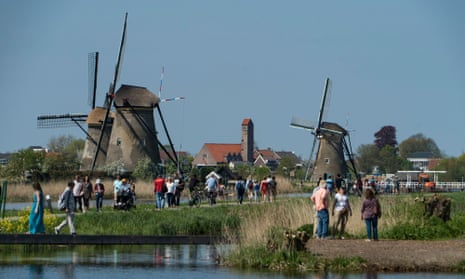 Tourists visit windmills in the village of Kinderdijk in the Netherlands.