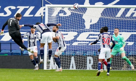 Alisson heads in a late goal against West Brom in May 2021