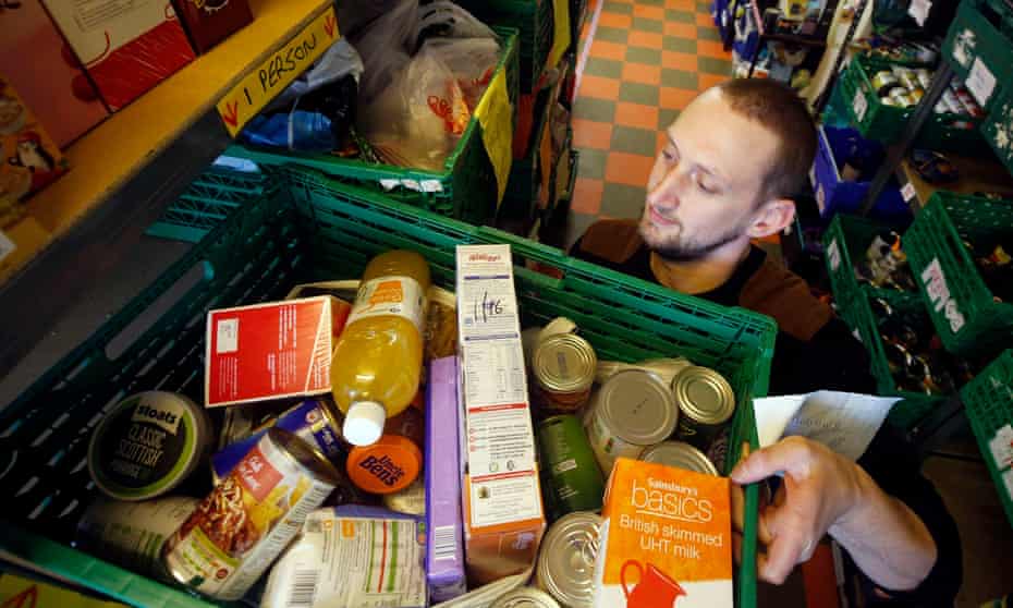 Worker at a foodbank carry produce