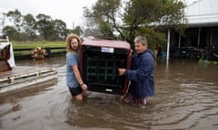 Tully and Stan Gray help save some of their neighbour Shane Rowley’s household belongings from flood waters