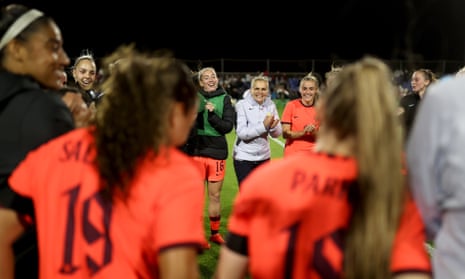 England manager Sarina Wiegman and her players huddle after the match