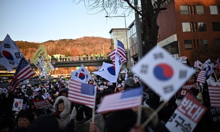 Protesters holding South Korean flags