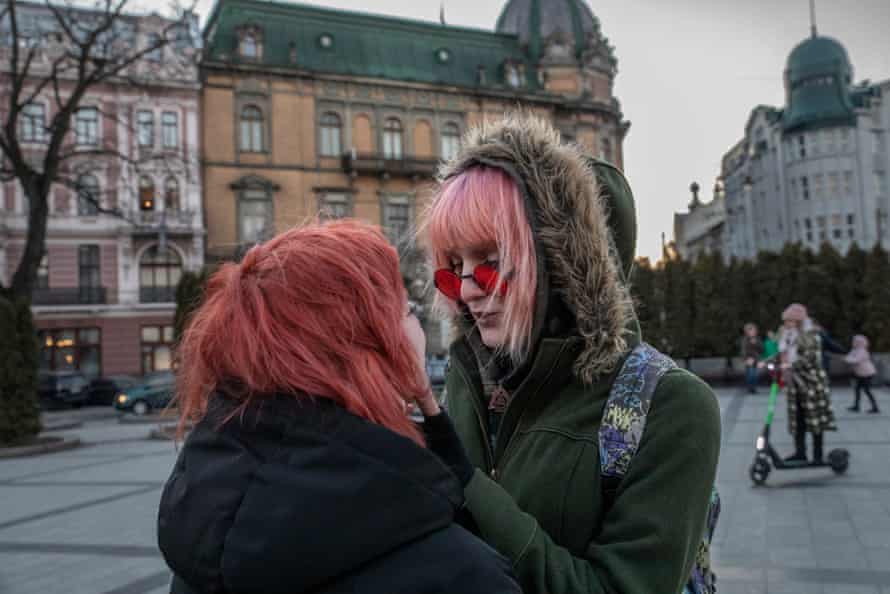 Two women stand together in the centre of Lviv in Ukraine.