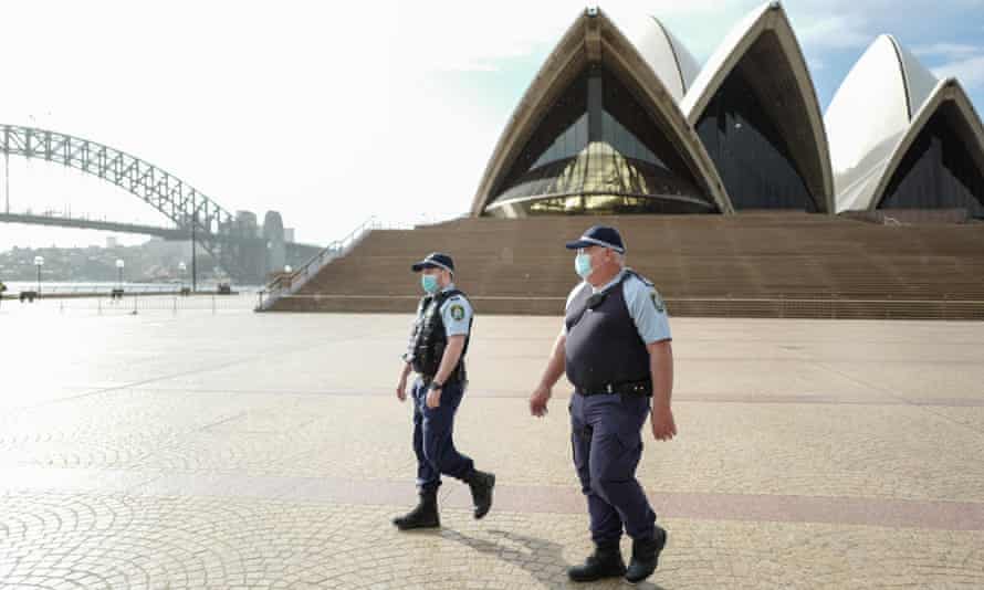 Police officers patrol at the Sydney Opera House amid Covid lockdown.