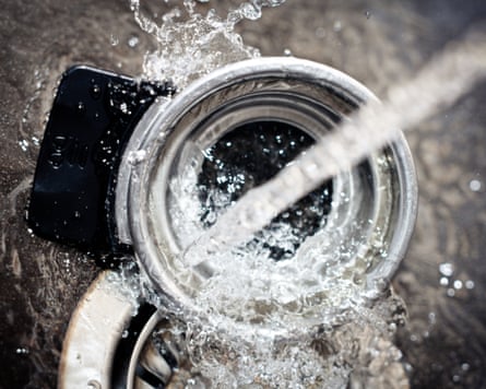 Running water in a sink, water splashing on kitchen utensil, equipment