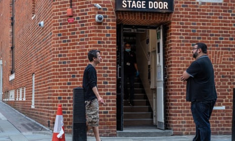 Theatre workers outside a stage door
