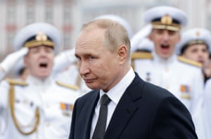 Vladimir Putin attends a parade marking Navy Day in Saint Petersburg, Russia