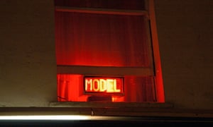 Neon sign advertising a live model or prostitute.