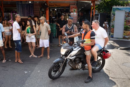 Paul Boswell on the back of a motorbike in Rio
